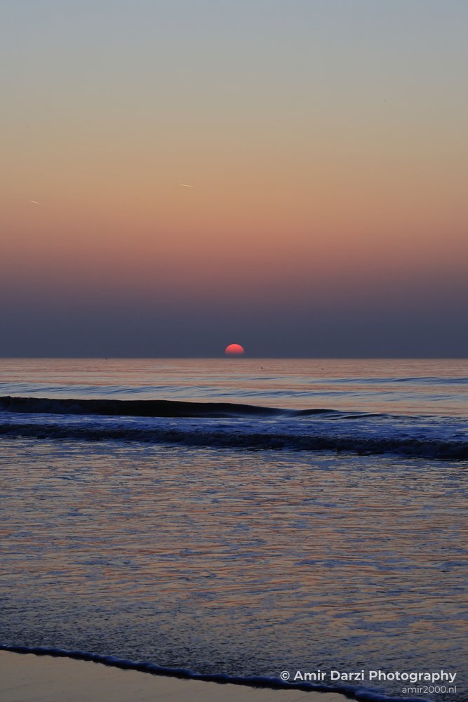 North sea sunset with gentle waves, north sea, and horizon.