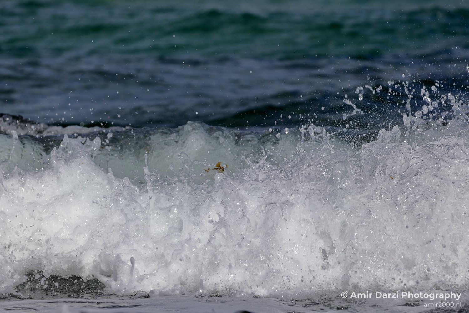 Foamy waves breaking along the Tel Aviv coast at the water edge.
