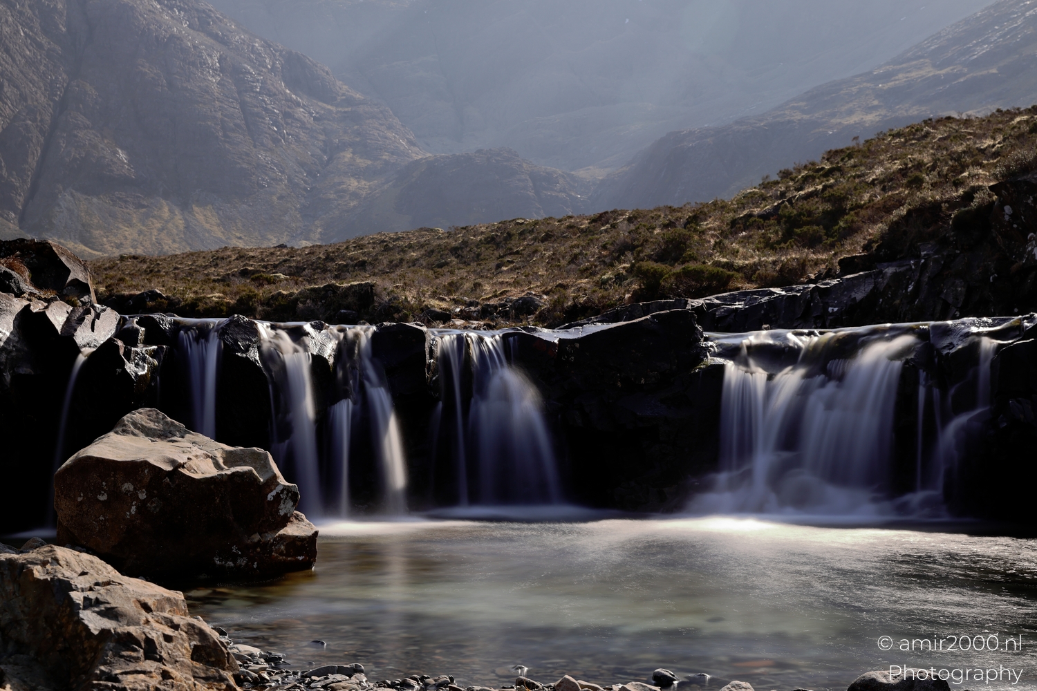 Fairy Pools waterfalls flowing over dark rocks into lower pool in Glen Brittle
