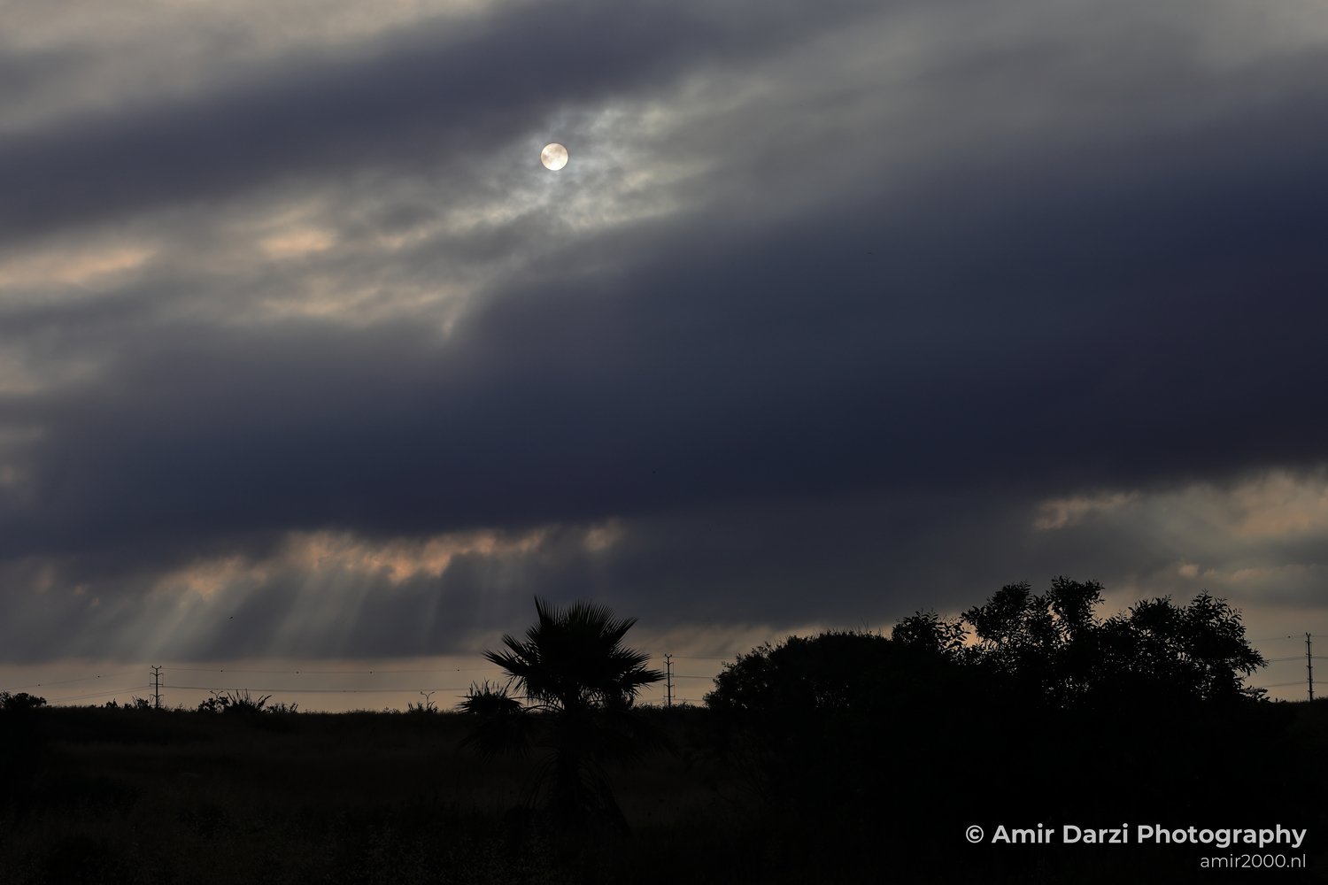 Dark clouds dominating most of the scene appear with the dramatic sky in Tel Aviv Jaffa, Israel.