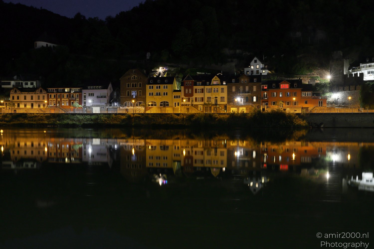 Riverside lights reflecting across the water in Cochem, Rhineland-Palatinate, Germany