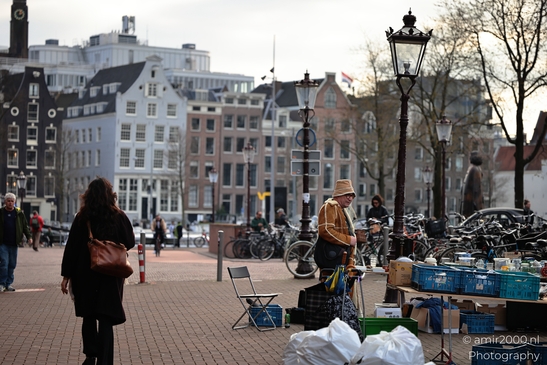 People selling items, crates on table in Amsterdam, Netherlands. - image from year 2026 #002