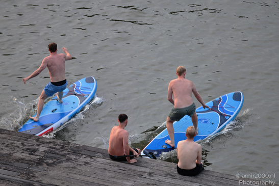 Men: Paddleboarding on a body of water includes four individuals engaging in Amsterdam, Netherlands. image from year 2026 #9