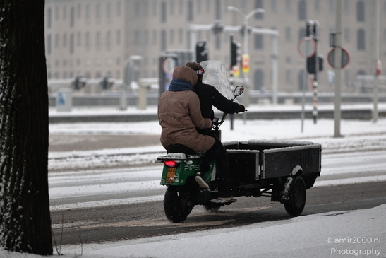 Snow_And_People_On_Scooter_Amsterdam_Netherlands_People_Creative_Collection_Photography_Canon_EOS_R5_Mark_II_2026_001.JPG