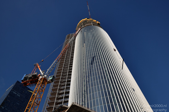 Azrieli Spiral Tower construction with scaffolding, cranes, and a clear blue sky in Tel Aviv - image from year 2026 #006