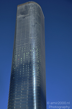 A tall, cylindrical skyscraper with a reflective glass facade in Givatayim, Israel. - image from year 2026 #003