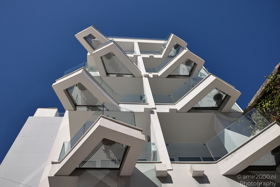 A modern architectural structure with a geometric design against a clear blue sky in Larnaca, - image from year 2026 #003