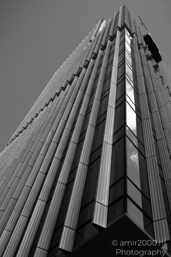 A towering skyscraper with a unique architectural design stands against the sky. - image from year 2026 #001