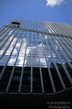 Vinoly Tower a tall glass building reflects the blue sky and clouds. - image from year 2026 #004
