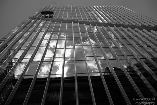 Vinoly Tower a tall skyscraper reflects the sky and clouds in its glass facade. - image from year 2026 #005