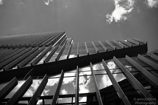 A modern building with reflective glass windows and an angular architectural design set against - image from year 2026 #006