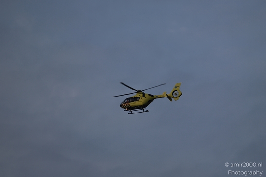 Ambulance ANWB flying in a cloudy sky over Amsterdam. image from year 2026 #1