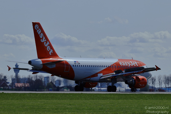 An EasyJet aircraft on a runway with its landing gear deployed and grassy fields surrounding it - image from year 2026 #004