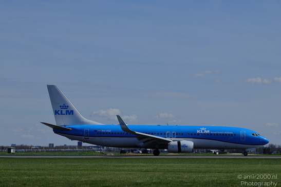 A KLM Royal Dutch Airlines aircraft on an airport runway under clear skies with sparse clouds in - image from year 2026 #003