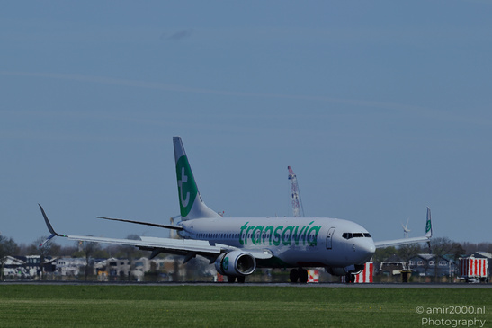 A Transavia airplane on an airport runway with its tail and part of the fuselage, featuring - image from year 2026 #001