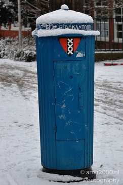 Blue_Postbox_With_Snow_On_Top_Amsterdam_Netherlands_Cityscape_Photography_Canon_EOS_R5_Mark_II_2026_001.JPG