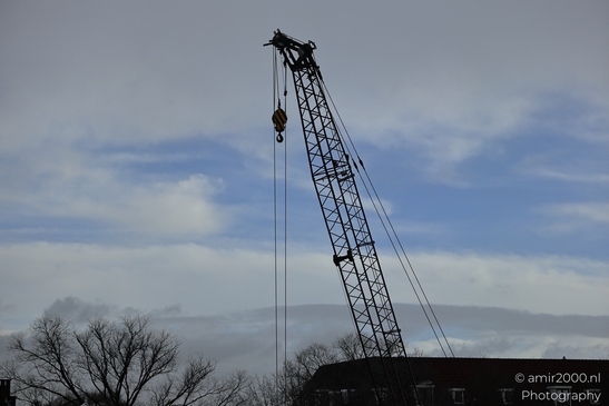 Construction_Crane_With_Yellow_Striped_Hook_Over_Amsterdam_Netherlands_Cityscape_Photography_Canon_EOS_R5_Mark_II_2026_001.JPG