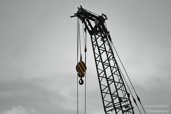 Construction_Crane_With_Yellow_Striped_Hook_Over_Amsterdam_Netherlands_Cityscape_Photography_Canon_EOS_R5_Mark_II_2026_002.JPG
