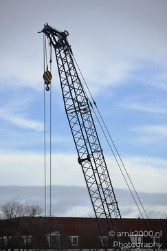 Construction_Crane_With_Yellow_Striped_Hook_Over_Amsterdam_Netherlands_Cityscape_Photography_Canon_EOS_R5_Mark_II_2026_003.JPG