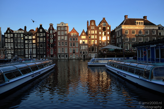 Damrak_Canal_Houses_At_Golden_Hour_Amsterdam_Netherlands_Cityscape_Photography_Canon_EOS_R5_Mark_II_2026_001.JPG