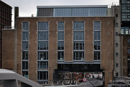 An industrial style brick building featuring contemporary architecture elements such as expansive image from year 2026 #1