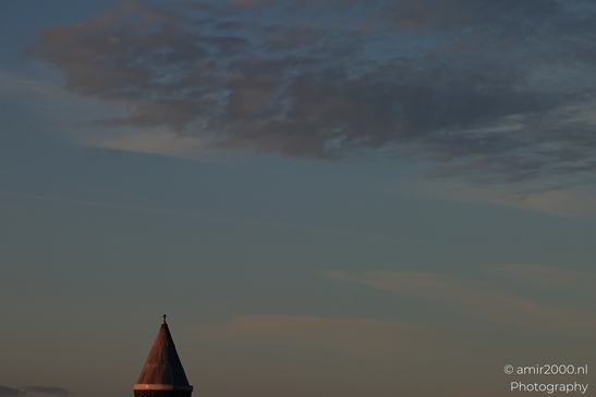 Pointed Rooftop Detail framed against a cloudy sky with minimal architectural detail. - image from year 2026 #001