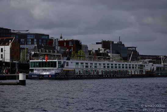 A river with a large cruise ship named "Lady Dillinger" docked near a waterfront area featuring - image from year 2026 #002