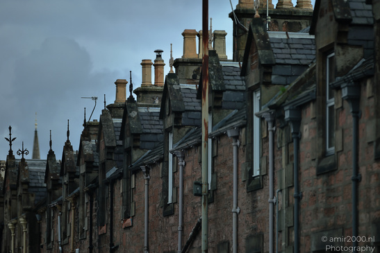 A row of buildings with slate roofs and chimneys, featuring brick facades and various - image from year 2026 #003