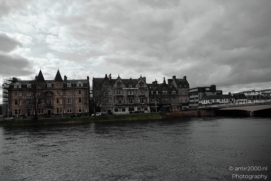 Scottish City Inverness a grayscale photograph of a river with buildings along the shore under - image from year 2026 #008