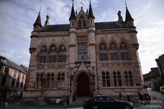 Scottish City Inverness a historic building with Gothic architecture features a red door and - image from year 2026 #010