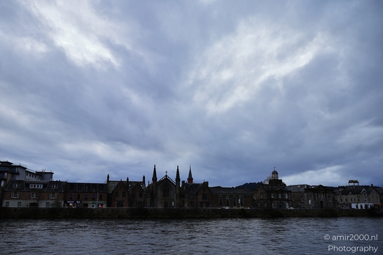 A Scottish cityscape with a church spire and cloudy sky. - image from year 2026 #017