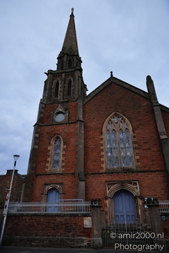 A historic church with a tall spire and stained glass windows in the Scottish Highlands. - image from year 2026 #018