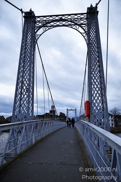 Scottish City Inverness a view of a suspension bridge with intricate lattice work under an - image from year 2026 #023