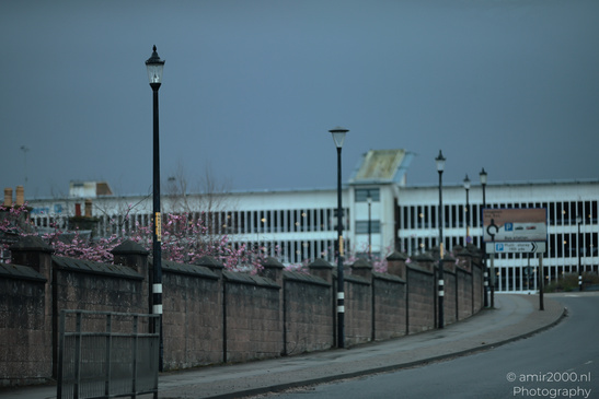 Scottish City Inverness a urban street lined with lampposts and a brick wall adorned with - image from year 2026 #046