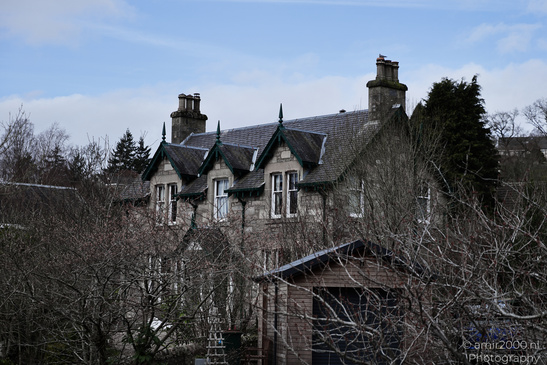 Town Pitlochry a quaint Victorian style house with a steeply pitched roof and ornate detailing - image from year 2026 #003