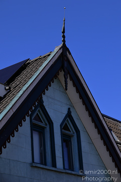 Village Ilpendam a close up of a buildings roof and window with a clear blue sky. - image from year 2026 #005