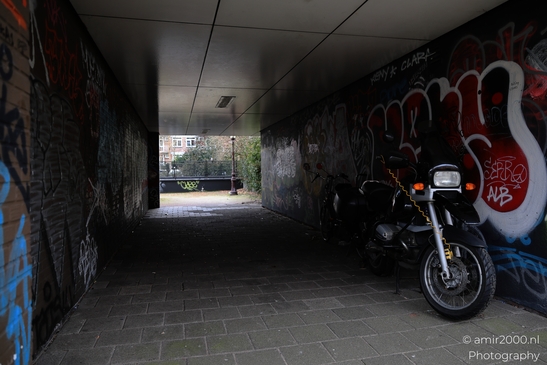 Urban_Artistry_Graffitiadorned_Tunnel_With_Motorcycles_Amsterdam_Netherlands_Cityscape_Photography_Canon_EOS_R5_Mark_II_2026_001.JPG