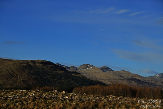 Clear view of a mountain slope with visible snow patches in the distance in Scotland United - image from year 2026 #001