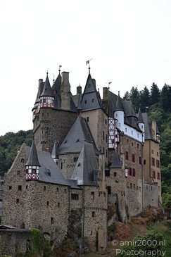 A medieval castle with intricate architecture and a rocky foreground in Rhineland Palatinate, - image from year 2026 #007
