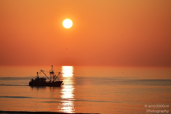 A fishing boat sails on calm waters as the sun sets. - image from year 2026 #005