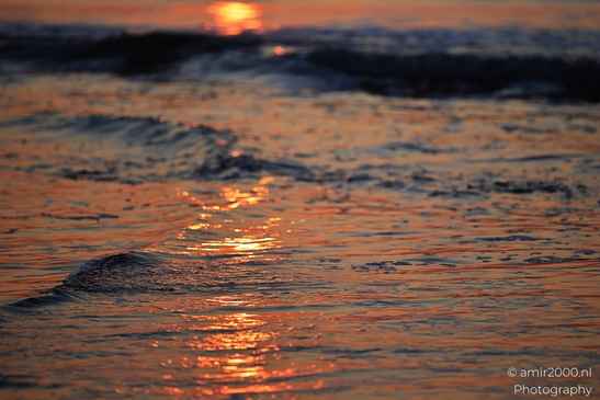 A sunset over the North Sea, with waves gently lapping against the shore. - image from year 2026 #005