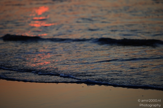 A sunset over the North Sea, with waves gently lapping against the shore. - image from year 2026 #010