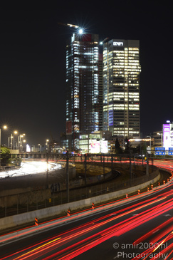 Aerial view of a cityscape at night with illuminated skyscrapers and a busy highway. - image from year 2026 #002