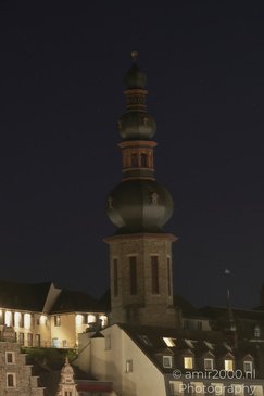 A tall, ornate tower with a green dome and a golden spire at the top in Cochem Rhineland - image from year 2026 #012