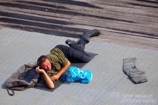A_man_waking_up_from_a_nap_on_the_wooden_dock_Amsterdam_Netherlands_Canon_EOS_5D_Mark_IV.JPG