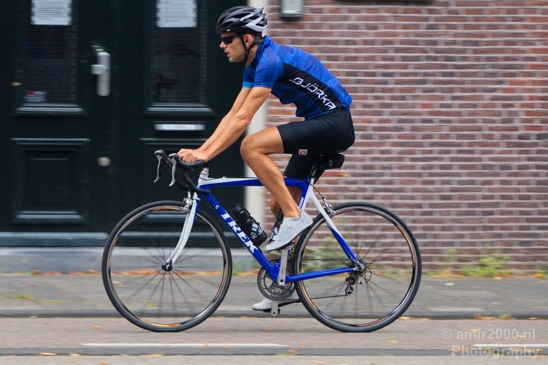 A_road_cycler_on_blue_Trek_bicycle_Amsterdam_Netherlands_Canon_EOS_5D_Mark_IV.JPG