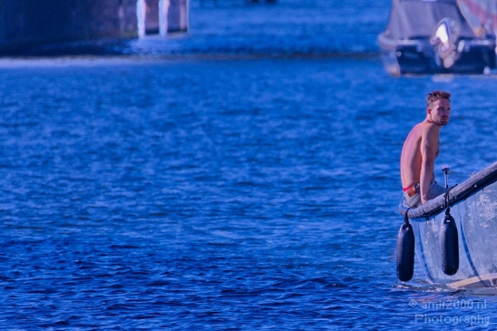 Guy_sitting_on_boat_edge_in_the_canal_Amsterdam_Netherlands_Canon_EOS_5D_Mark_IV.JPG