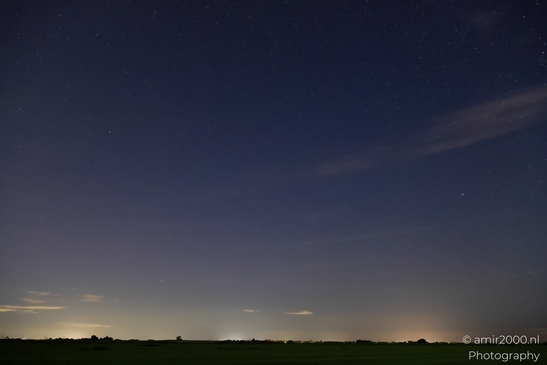 A stormy night sky over Noord-Holland, Netherlands, with clouds and stars visible in - image from year 2025 #034