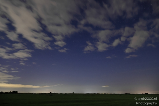 A stormy night sky in Noord-Holland, Netherlands, with a cloudy horizon and stars shining - image from year 2025 #038